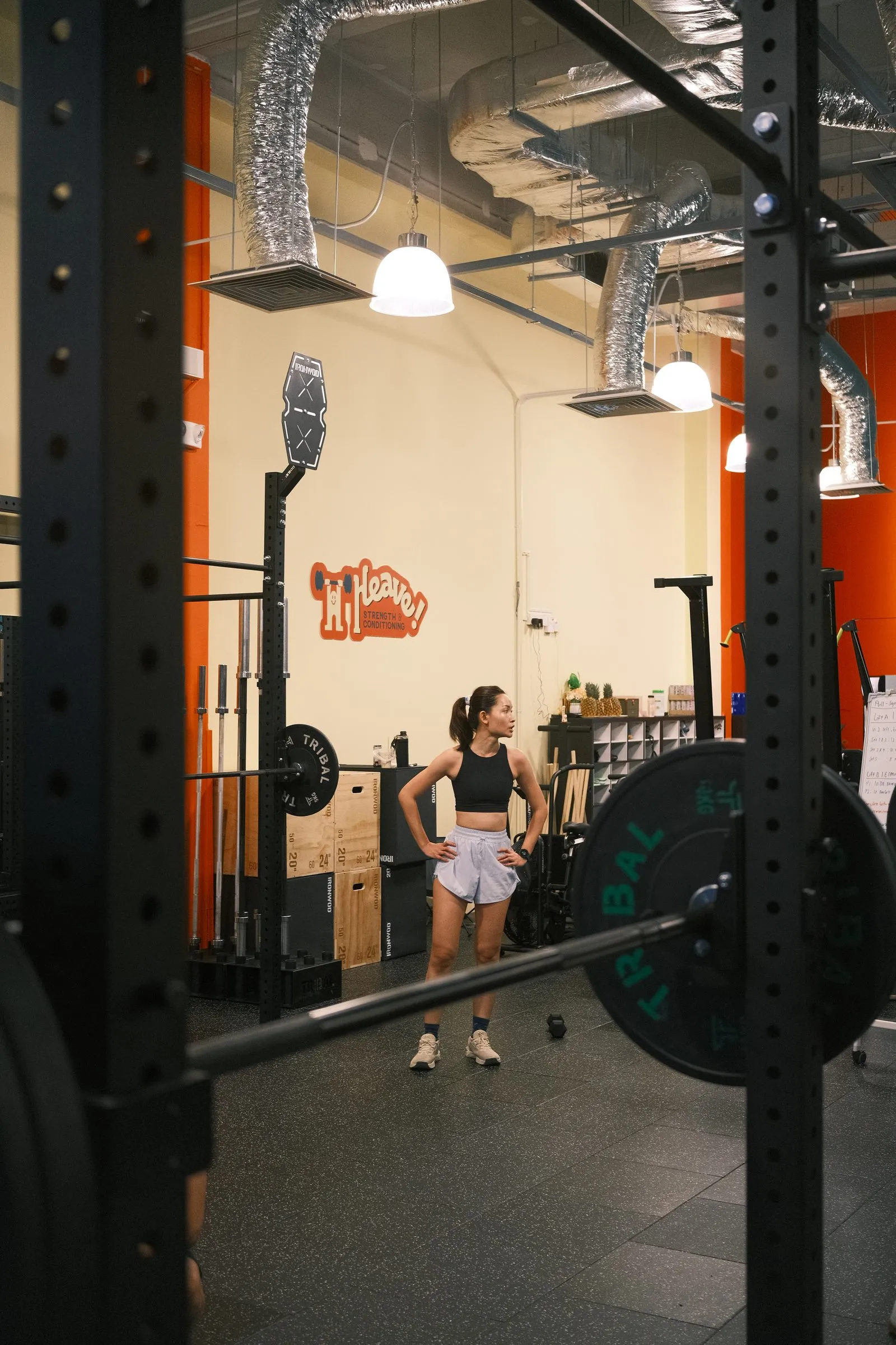 A member between sets under the Heave sign, seen through a squat rack.